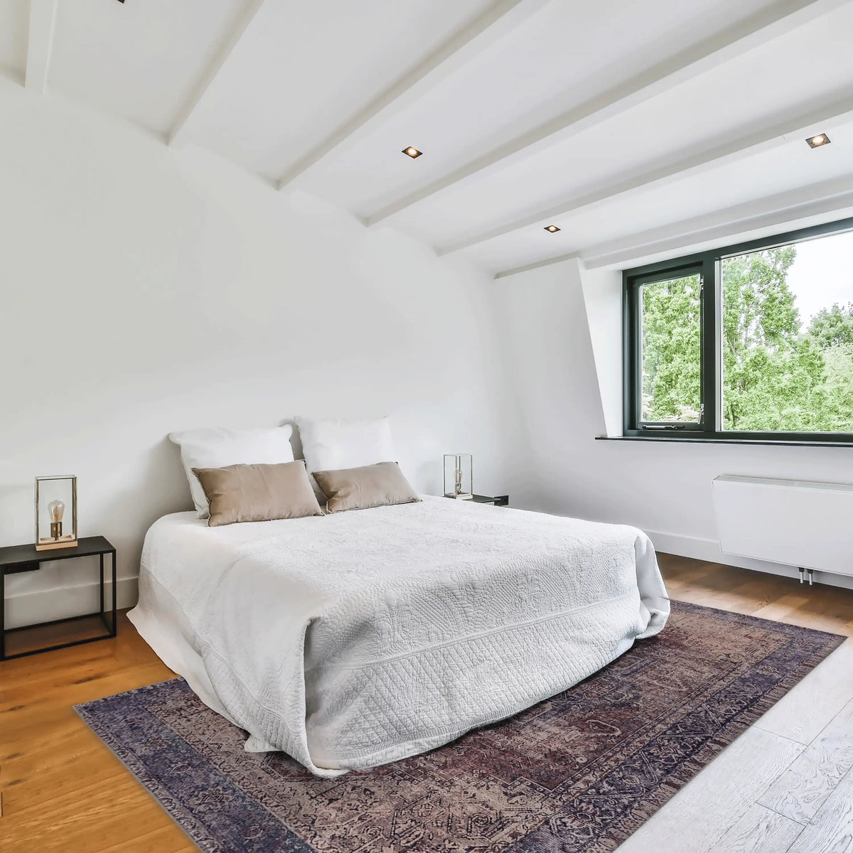 Modern bedroom with a bed, nightstands, and a large window.